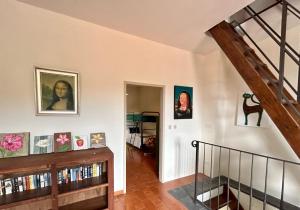 una escalera en una casa con fotos en la pared en Villa delle Fonti - Villa with pool en Toano
