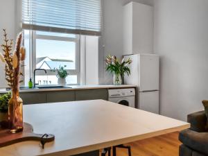 a kitchen with a table and a refrigerator at Main Street Flat B - Uk46449 in Ayr