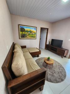 a living room with a couch and a table at Casa Campo - Domo do Matto in Garanhuns