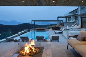 a fire pit on a patio next to a pool at Escape View Villa Lefkada in Fternón