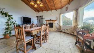 a dining room with a table and chairs and a fireplace at La gringa 1 in San Carlos de Bariloche