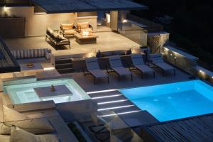 an overhead view of a swimming pool at night at Escape View Villa Lefkada in Fternón