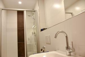 a bathroom with a sink and a shower at Haus Sandkorn in Baltrum