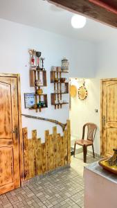 a room with wooden doors and a chair at Apartment in Safi near the beach the sea calm down in Safi