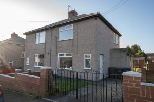 a brick house with a fence in front of it at Modern - 2 Bed - Free Parking in Coxhoe