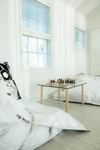 a white room with a table and a bed at White House in Kokkola