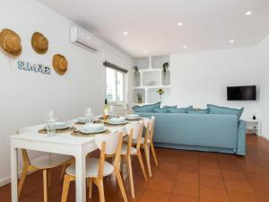 a living room with a table and a blue couch at Villa Double Joy - Privacy & Privat Pool & Garden & Top Location & Albufeira in Albufeira