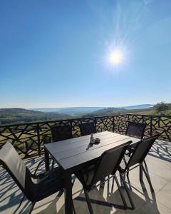 uma mesa e cadeiras numa varanda com vista em Wine Valley Villas em Lipovac