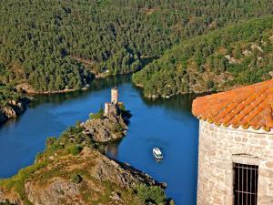 an island in the middle of a river with a castle at Gîte Saint-Héand, 2 pièces, 2 personnes - FR-1-496-144 in Saint-Héand