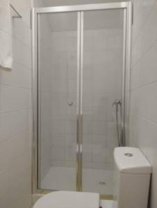 a shower with a glass door in a bathroom at University View Loft in Coimbra