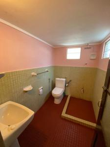 a bathroom with a white toilet and a sink at Sujatha Villa Paradise in Tangalle +37 photos