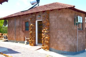 um edifício de tijolos com uma porta e um telhado em Crocodile Pools Resort em Gaborone