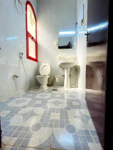 a bathroom with a toilet and a sink at Al Wehda Hotel in Dubai
