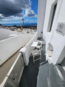 a balcony with chairs and tables on a ship at Mareva's House in Pyrgos