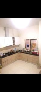 a kitchen with white cabinets and a white tile floor at Room Phnom Penh in Phnom Penh