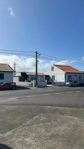 a parking lot with cars parked in front of buildings at Hortênsia's AL in Praia da Vitória