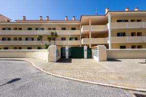 a building with a parking lot in front of it at Sea & Sunset by AcasaDasCasas in Ericeira