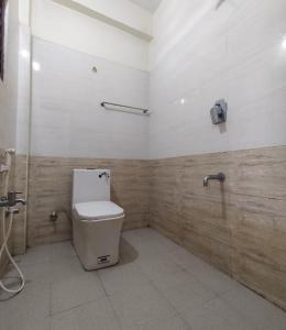 a bathroom with a toilet in a room at Taj City Hotel in Agra