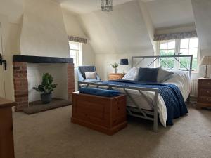 a bedroom with a bed and a fireplace at Sea Breeze in South Hayling