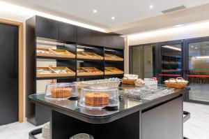 a bakery with a counter with cakes on it at Hotel Alvorada in Estoril