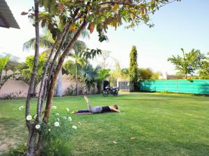 a man laying on the grass in a yard at Pari Resort with Nature View in Pushkar