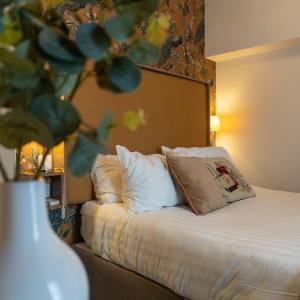 a bedroom with a bed with a pillow on it at Eccles Townhouse in Dublin