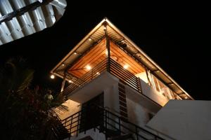 a building with lights on top of it at night at GREEN MOUNT RESORTS in Malaiyāndipattanam