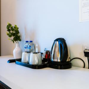 a black tea kettle and cups on a counter at Eccles Townhouse in Dublin