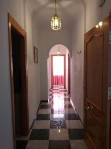 an empty hallway with a door and a window at Casa Benzambra in Cádiar