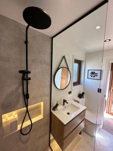 a bathroom with a sink and a mirror at Petite Perfection tiny house at Lake Hawea in Lake Hāwea