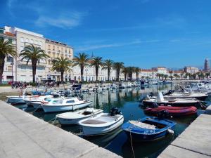 Un montón de barcos están atracados en un puerto en Beachfront Sunshine apartment en Split