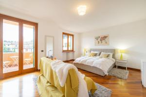 a bedroom with a bed and a balcony at Villa Calmasino - Swimming Pool and Garda Lake in Cavaion Veronese