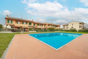 a swimming pool in front of a house at Villa Calmasino - Swimming Pool and Garda Lake in Cavaion Veronese