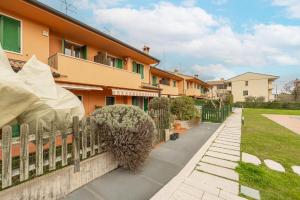 a fence in front of a house at Villa Calmasino - Swimming Pool and Garda Lake in Cavaion Veronese