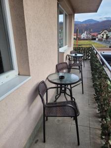 a row of tables and chairs on a balcony at Apartament Eva in Râşnov