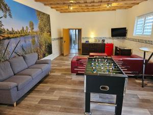 a living room with a foosball table in the middle at Gästehaus Bad Dürrenberg in Bad Dürrenberg