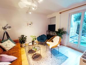 a living room with a couch and chairs at Peaceful apartment with private garden in Clichy