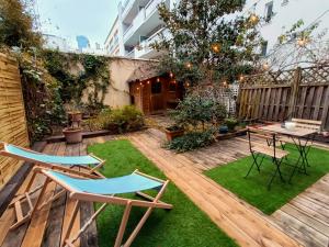 a patio with two chairs and a table in a yard at Peaceful apartment with private garden in Clichy