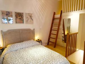 a bedroom with a bed and a stair case at Peaceful apartment with private garden in Clichy