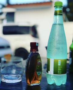 duas garrafas de água sentadas em cima de uma mesa em Rest Inn Lounge & Lodge em Dar es Salaam