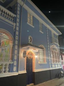 a blue building with a door with a wreath on it at Pousada Manga Rosa in Salvador