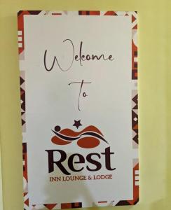 a sign that reads welcome to rest inn lounge and lodge at Rest Inn Lounge & Lodge in Dar es Salaam