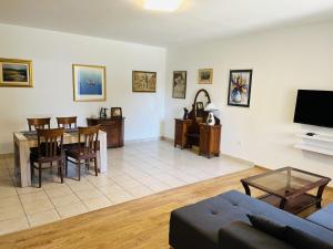 a living room with a couch and a dining room at Beachfront Sunshine apartment in Split