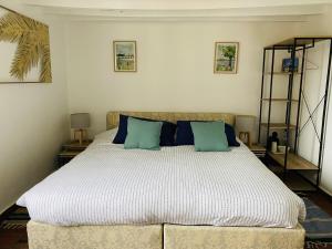 a bedroom with a large bed with blue pillows at Gîte de la Perdrix 