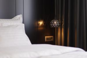 Postel nebo postele na pokoji v ubytování Gremmy Boutique Hotel