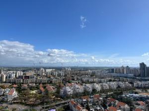 an aerial view of a city with tall buildings at Apartment about Lake in Netanya