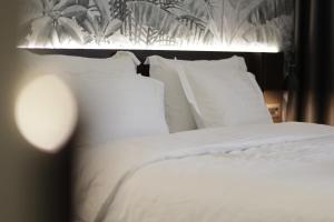 Postel nebo postele na pokoji v ubytování Gremmy Boutique Hotel