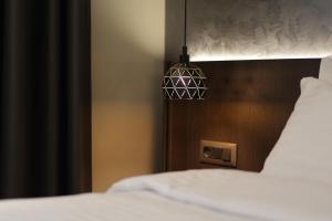 Postel nebo postele na pokoji v ubytování Gremmy Boutique Hotel