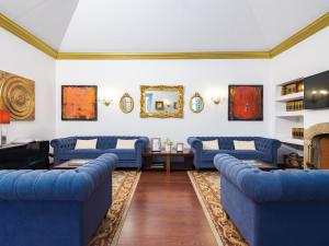 a living room with blue couches and a fireplace at Casa Senhoras Rainhas - Óbidos - by Unlock Hotels in Óbidos
