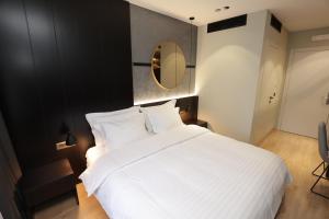 Postel nebo postele na pokoji v ubytování Gremmy Boutique Hotel